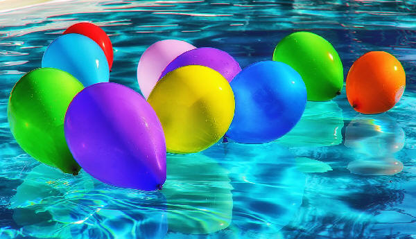 Colourful Balloons atop Rippling Water